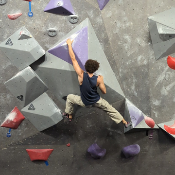 local man climbs an indoor boulder